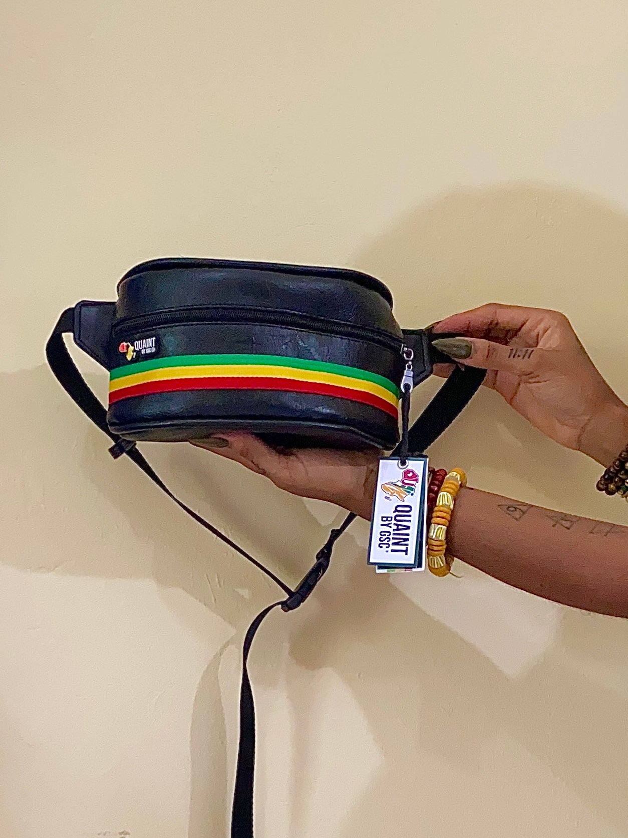 black vegan leather fanny pack with green yellow and red rasta stripes. afrocentric fanny pack style..