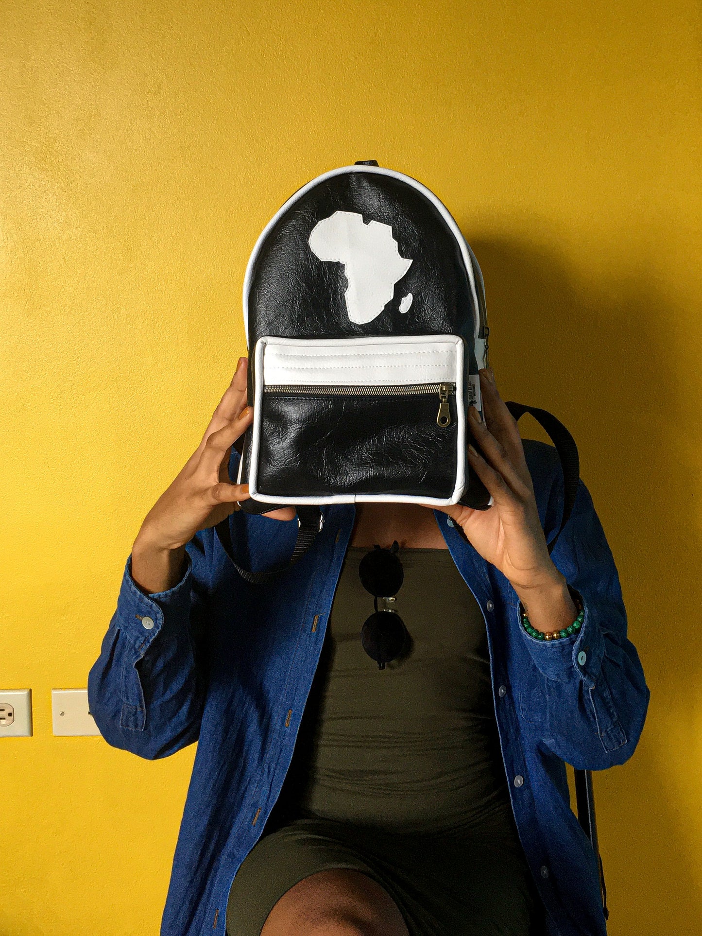 black leatherette backpack with map of africa outline on the front motherland backpack.